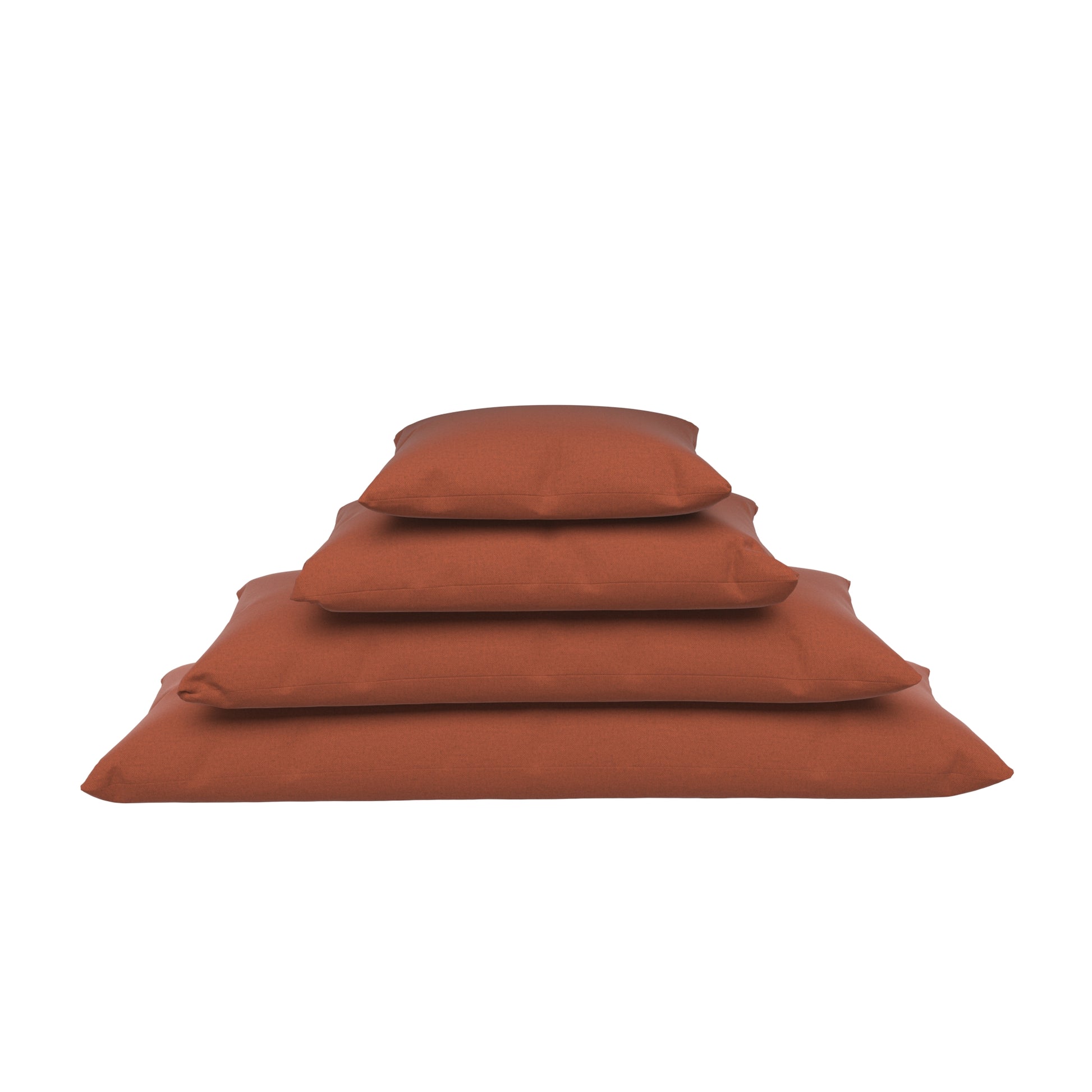 Four burnt orange lumbar pillow stacked on a white background.