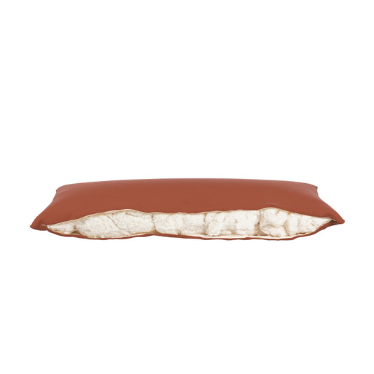 Product image of a body pillow with a burnt orange pillow cover. Zipper open showing cotton inside.