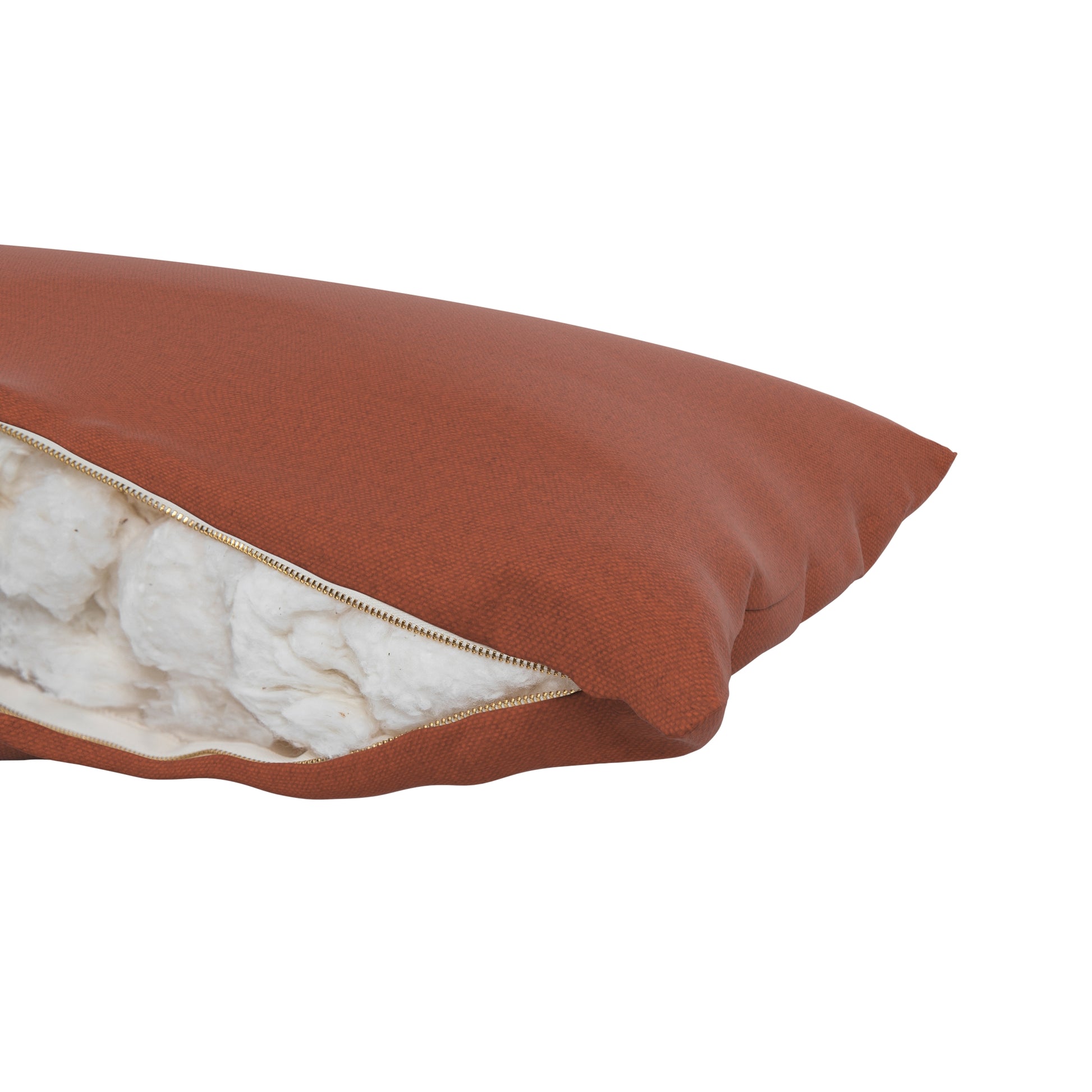 Product image of a body pillow with a burnt orange pillow cover. Zipper open showing cotton inside.