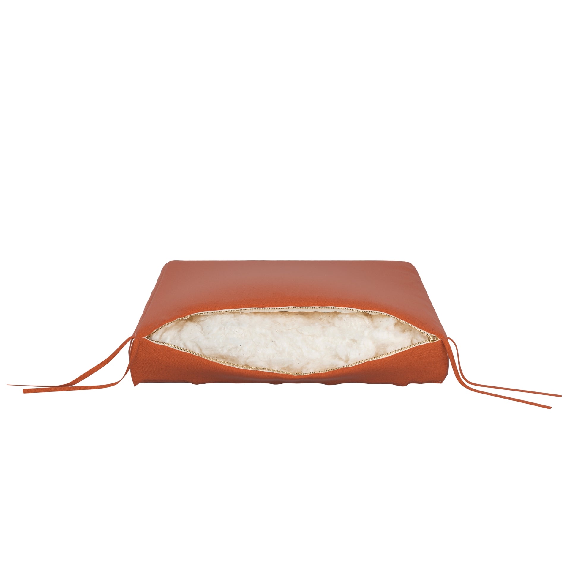 Burnt orange seat cushion on a white background. Zipper open showing cotton inside.