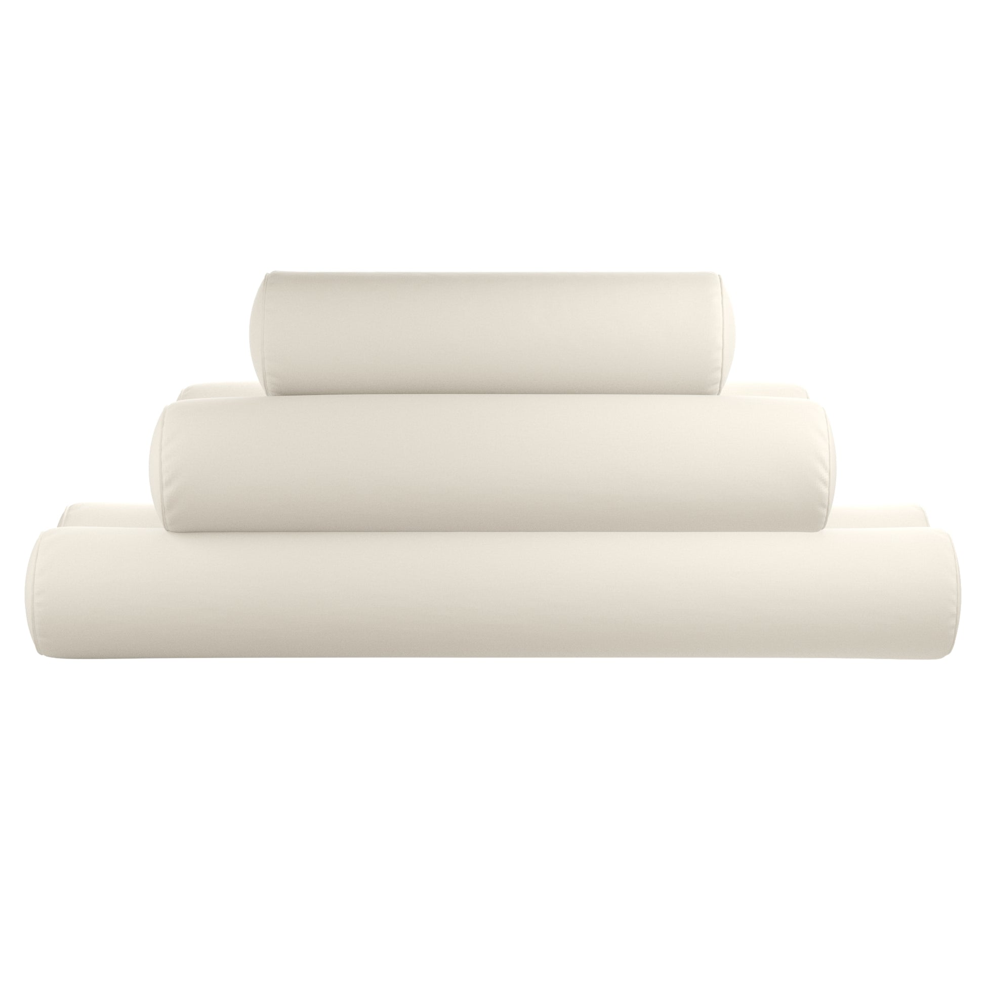 Natural white bolster pillows stacked on a white background.